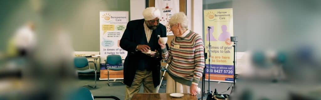Two people chat at a Bereavement Care event