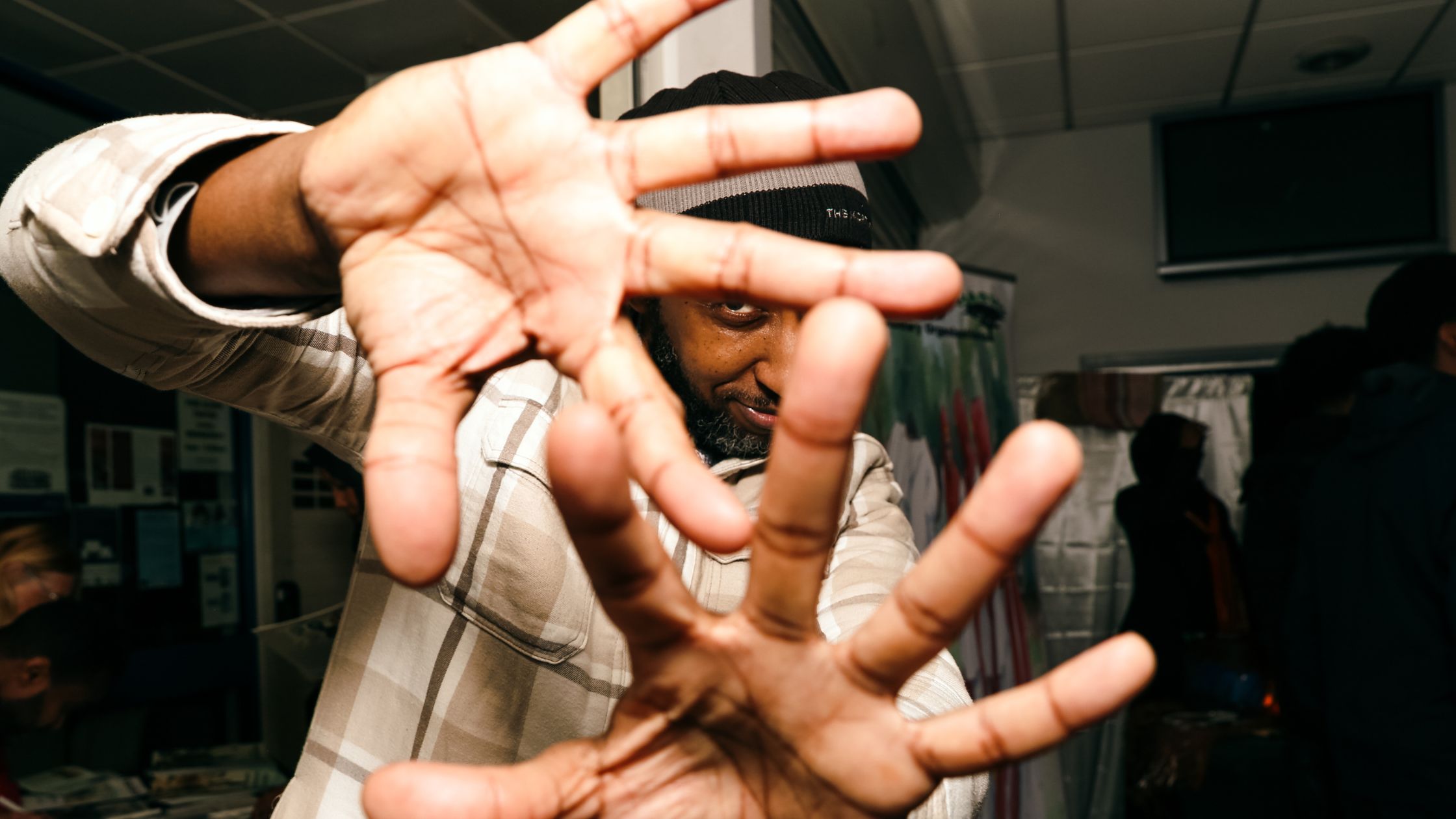 Man peeks through fingers at a HASVO event