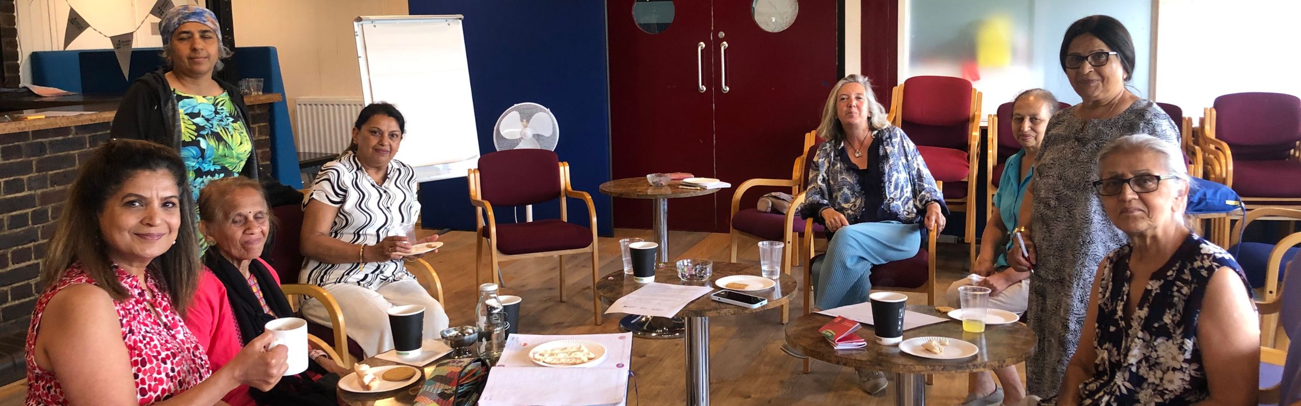 A group have tea at a Harrow Carers event