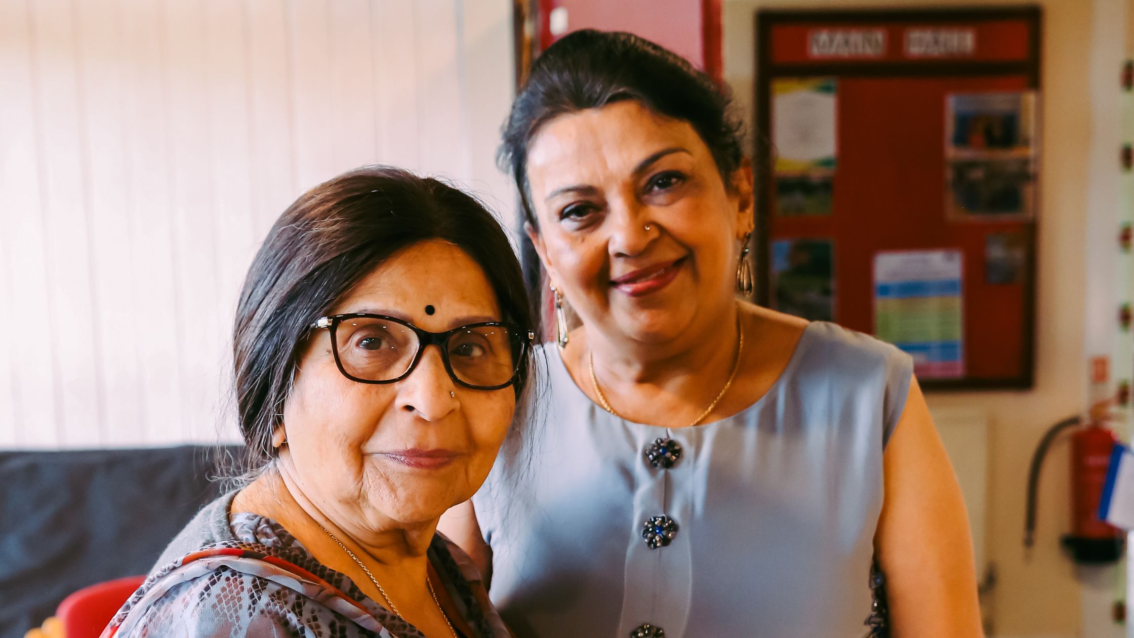 Two ladies smiling at Harrow Carers Diwali event