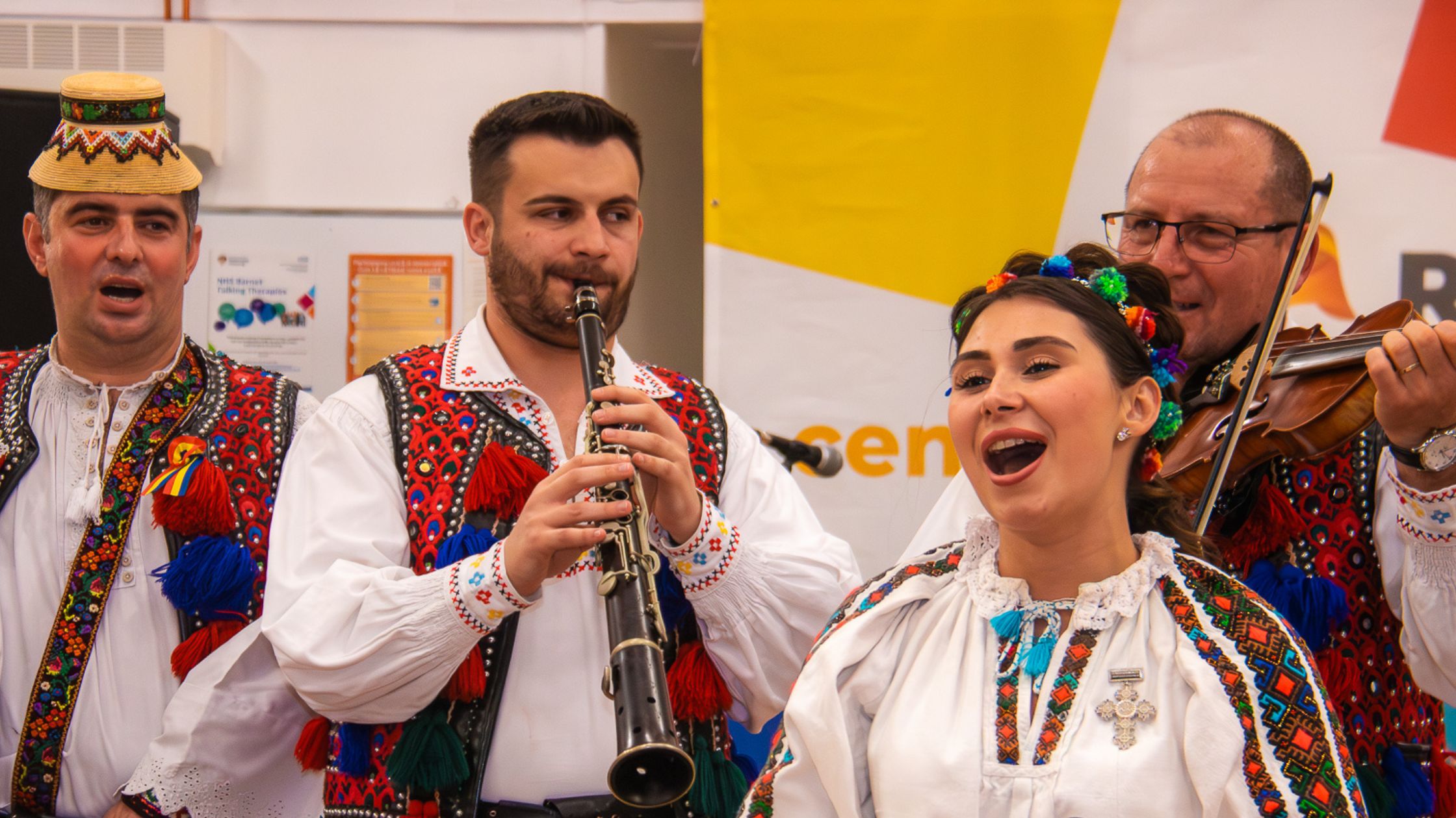 Performers in Romanian traditional dress at an RCCT event
