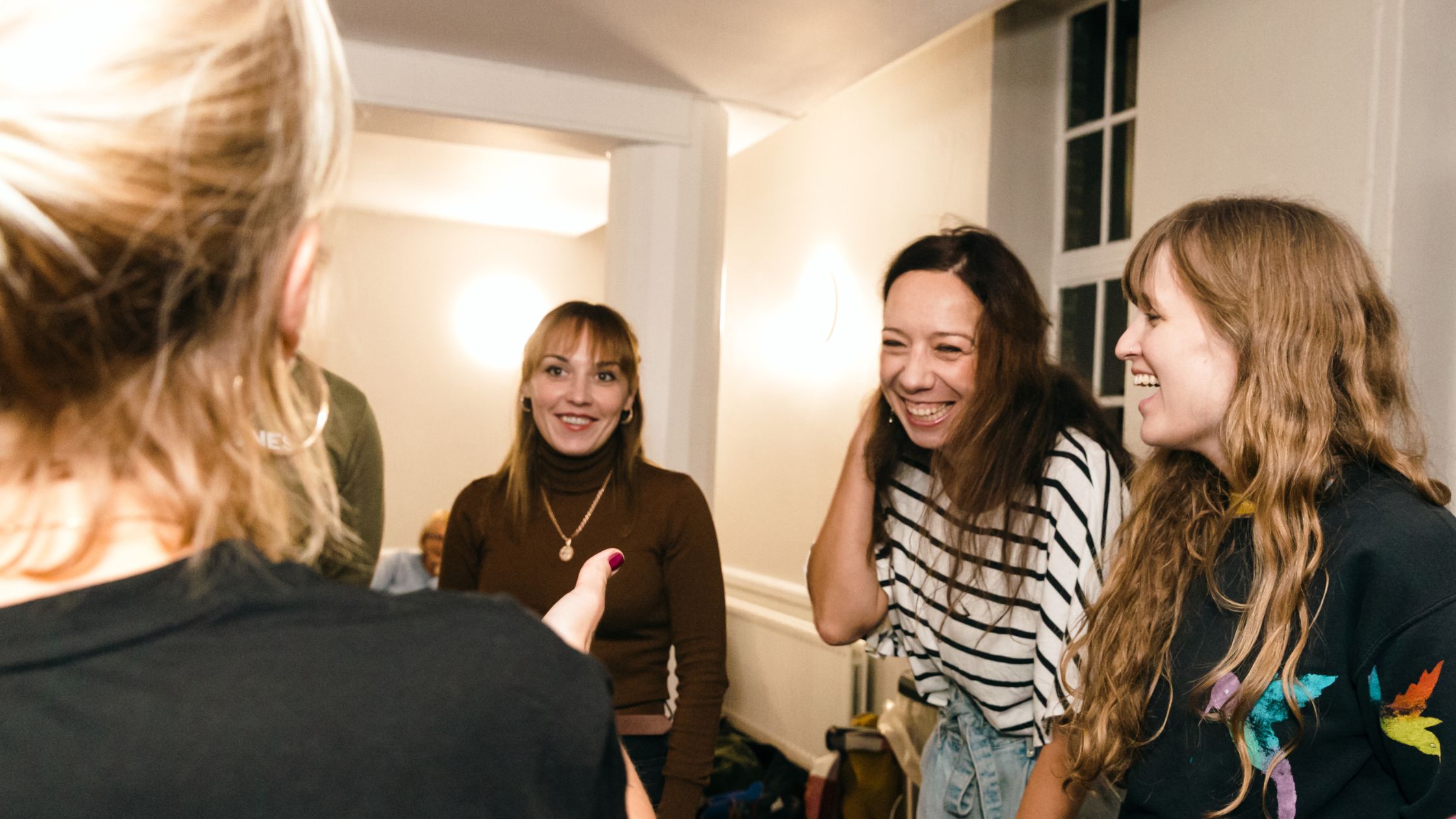 People laughing at a Unique Community workshop